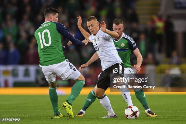 Belfast , United Kingdom - 5 October 2017; Joshua Kimmich of Germany is tackled by Kyle Lafferty, left, and Chris Brunt of Northern Ireland during...