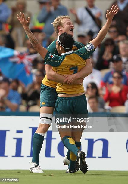 Henry Vanderglas and Richard Kingi of Australia celebrate after scoring a try during day two of the IRB Adelaide International Rugby Sevens match...