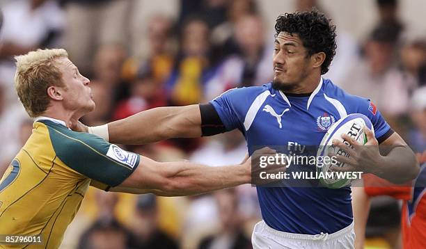 Samoa's Alafoti Fa'osiliva shrugs off the tackle of Australia's Henry Vanderglas in their match on the second day at the International Rugby Sevens...