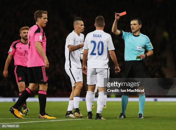 Robert Mak of Slovakia is shown a red card by referee Milorad Mazic and is sent off during the FIFA 2018 World Cup Group F Qualifier between Scotland...