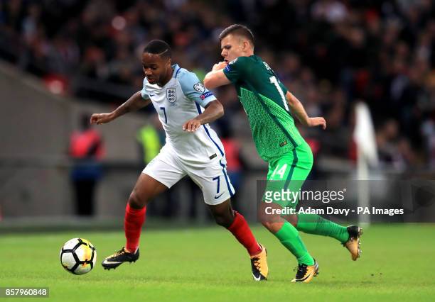 England's Raheem Sterling and Slovenia's Roman Bezjak battle for the ball during the 2018 FIFA World Cup Qualifying, Group F match at Wembley...