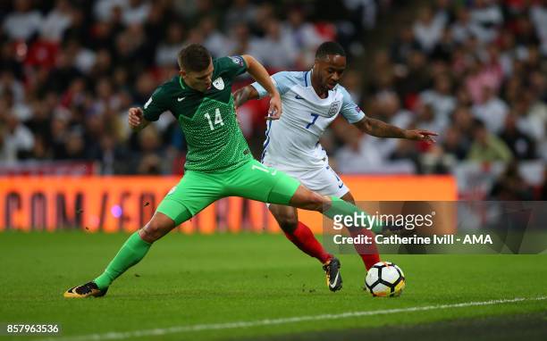 Raheem Sterling of England and Roman Bezjak of Slovenia compete for the ball during the FIFA 2018 World Cup Qualifier between England and Slovenia at...