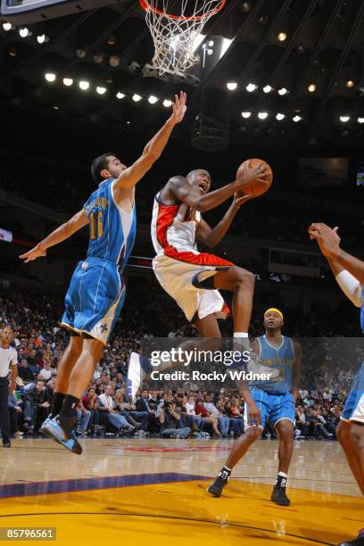 Jamal Crawford of the Golden State Warriors finishes on the reverse layup against the New Orleans Hornets on April 03, 2009 at Oracle Arena in...