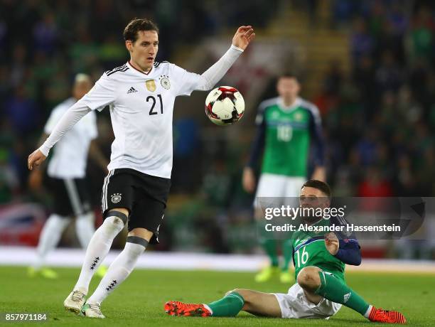 Sebastian Rudy of Germany is challenged by Oliver Norwood of Northern Ireland during the FIFA 2018 World Cup Qualifier between Northern Ireland and...