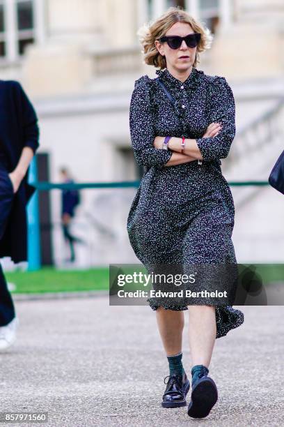 Guest wears sunglasses, a dress, shoes, outside Moncler, during Paris Fashion Week Womenswear Spring/Summer 2018, on October 3, 2017 in Paris, France.