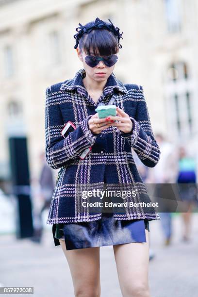 Guest wears sunglasses, a tartan checkered jacket, outside Moncler, during Paris Fashion Week Womenswear Spring/Summer 2018, on October 3, 2017 in...
