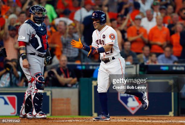 Jose Altuve of the Houston Astros celebrates after hitting a home run in the first inning against the Boston Red Sox during game one of the American...
