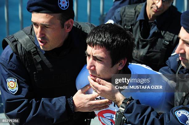 Turkish riot policemen arrest a protestor during an anti-Nato protest at Bosphorus Bridge in Istanbul on April 4, 2009. NATO leaders sought new ways...