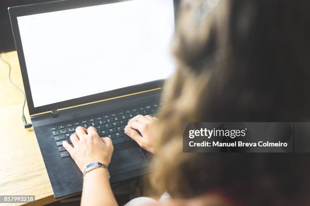 working on a laptop - story telling in the workplace stock pictures, royalty-free photos & images