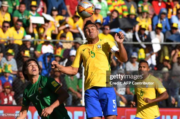 Brazil's Casemiro heads the ball next to Bolivia's Marcelo Martins during their 2018 World Cup qualifier football match against Bolivia in La Paz on...