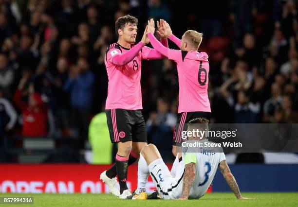 Chris Martin and Barry Bannan of Scotland celebrate victory as Martin Skrtel of Slovakia looks dejected after the FIFA 2018 World Cup Group F...