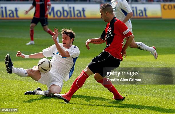 Dusan Vasiljevic of Cottbus clears the ball against Benjamin Koehler of Frankfurt before referee Peter Gagelmann decides on penalty during the...