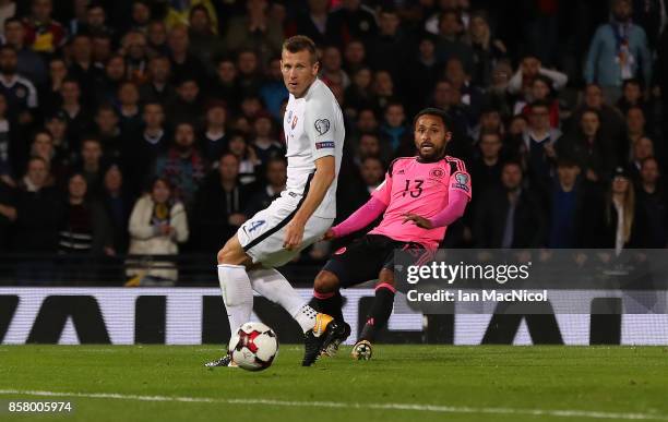 Ikechi Anya of Scotland plays the ball in for Martin Skrtel of Slovakia to score an own goal during the FIFA 2018 World Cup Qualifier between...