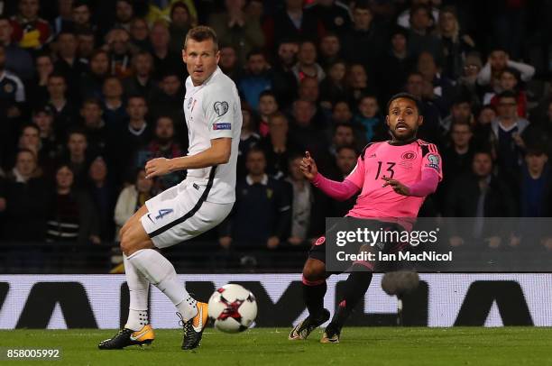 Ikechi Anya of Scotland plays the ball in for Martin Skrtel of Slovakia to score an own goal during the FIFA 2018 World Cup Qualifier between...