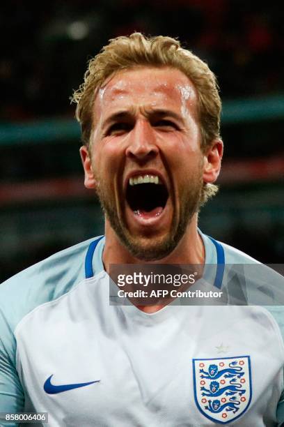England's striker Harry Kane celebrates scoring the opening goal during the FIFA World Cup 2018 qualification football match between England and...