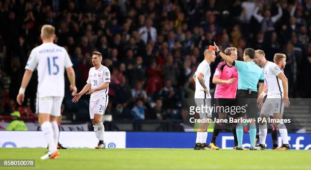 Slovakia players protest to referee Milorad Mazic after Robert Mak is shown a red card for a second bookable offence during the 2018 FIFA World Cup...