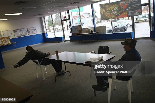 Workers Nathaniel Howard and Brian Bradburry wait for work at a day labor center April 4, 2009 in economically depressed Binghamton, New York. A...