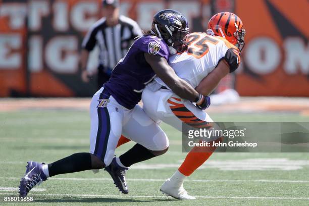 Mosely of the Baltimore Ravens makes the tackle on Tyler Eiifert of the Cincinnati Bengals during their game at Paul Brown Stadium on September 10,...