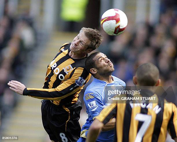 Hull City's Nick Barmby vies with Portsmouth's Hayden Mullins during an English FA Premier League, football match, at the KC Stadium, Kingston upon...