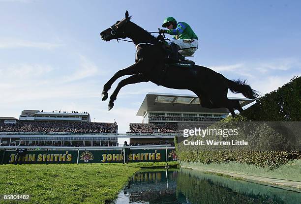 Black Apalachi ridden by Denis O'Regan jumps the water jump during the John Smith's Grand National Steeple Chase Handicap at Aintree on April 4, 2009...