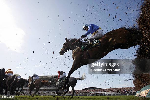 Graham Lee rides THREE MIRRORS over the last fence during the John Smith's Maghull Novices' Steeple Chase on the third day of the Grand National...