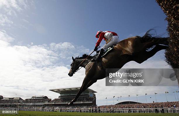 Graham Lee rides KALAHARI KING over a fence during the Grand National at Aintree Racecourse in Liverpool, north-west England on April 4, 2009. Rank...