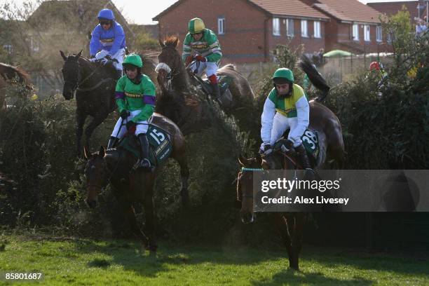 Mon Mome ridden by Liam Treadwell clears Becher's Brook alongside Idle Talk ridden by Brian Harding on the way to victory in the John Smith's Grand...