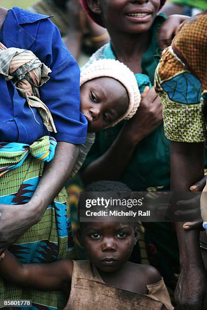 Local women and children gather as Madonna visits the village of Mugulula on April 3, 2009 on the outskirts of Lilongwe, Malawi. Her visit was a...