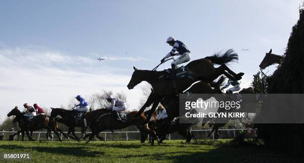 Horses clear the 'Beechers Brook' fence following two false starts during the Grand National Steeple Chase on the third day of the Grand National...