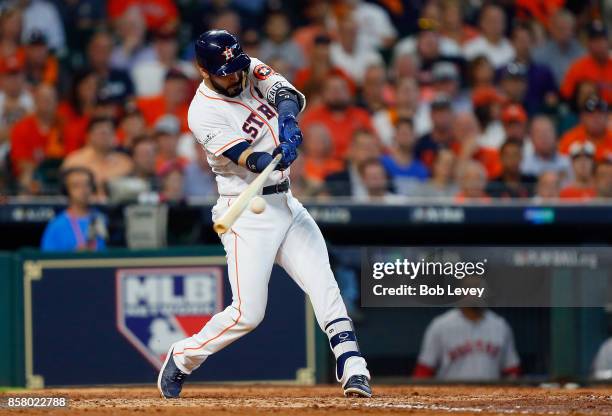 Marwin Gonzalez of the Houston Astros hits a two-run RBI double in the fourth inning against the Boston Red Sox during game one of the American...