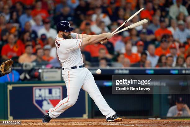 Evan Gattis of the Houston Astros breaks his bat in the fourth inning against the Boston Red Sox during game one of the American League Division...