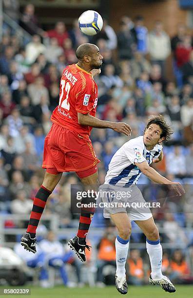 Sevilla's French born Frédéric Kanouté fights for the ball with Recreativo Huelva's Barber during their Spanish league football match at the Nuevo...