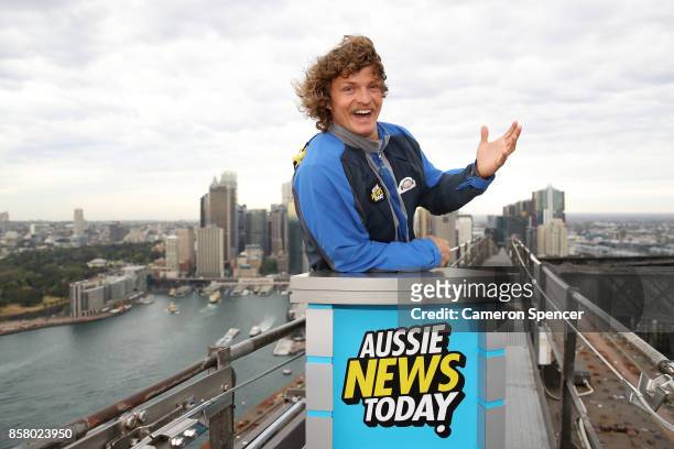 Nick Cummins delivers the first news bulletin for Aussie News Today from the top of the Sydney Harbour Bridge on October 6, 2017 in Sydney, Australia.