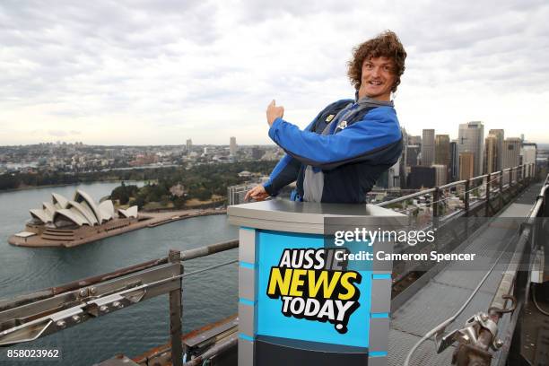 Nick Cummins delivers the first news bulletin for Aussie News Today from the top of the Sydney Harbour Bridge on October 6, 2017 in Sydney, Australia.