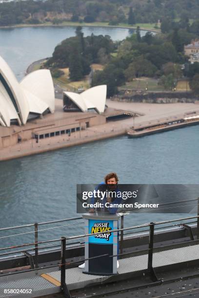 Nick Cummins delivers the first news bulletin for Aussie News Today from the top of the Sydney Harbour Bridge on October 6, 2017 in Sydney, Australia.