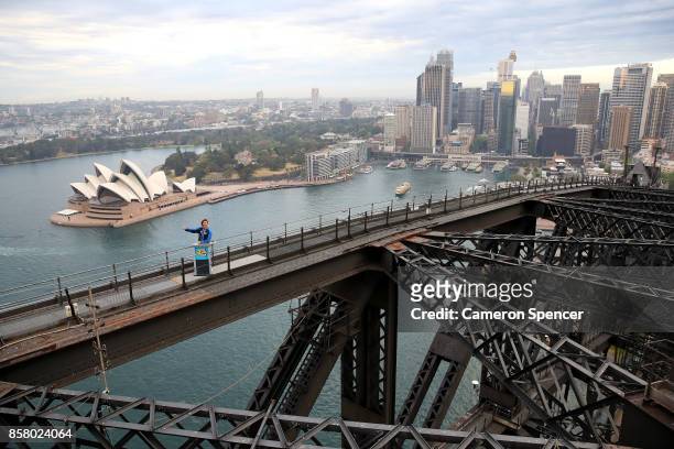 Nick Cummins delivers the first news bulletin for Aussie News Today from the top of the Sydney Harbour Bridge on October 6, 2017 in Sydney, Australia.