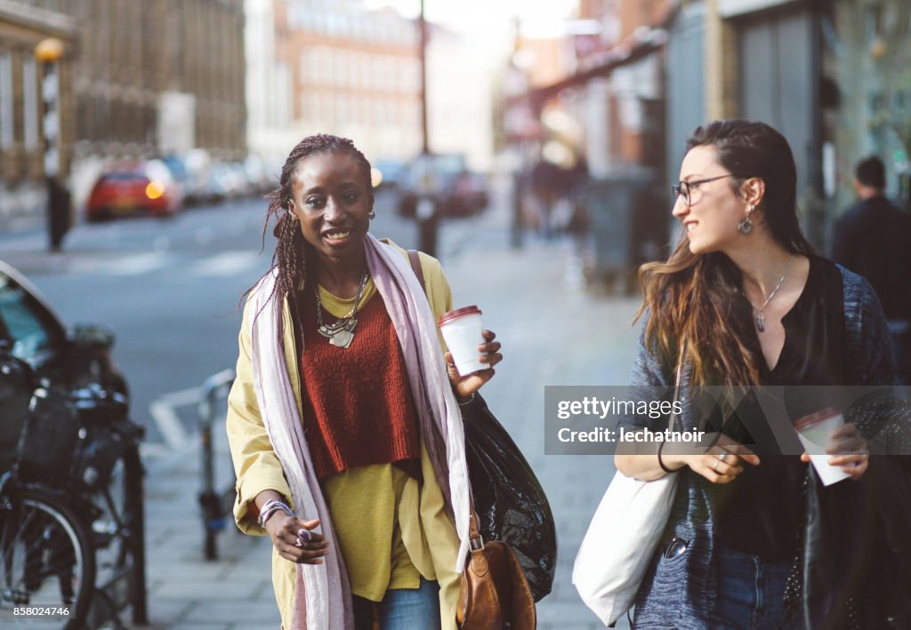 Young women walking together in London East End, UK