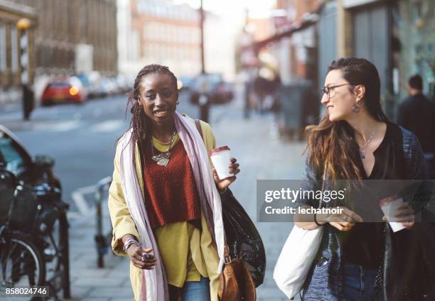 young women walking together in london east end, uk - east london stock pictures, royalty-free photos & images