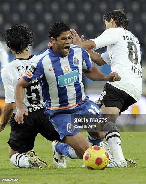 Porto's "Hulk" Sousa is tackled by Vitoria de Guimaraes� Gregory and Joao Alves during their Portuguese Liga football match at Afonso Henriques...