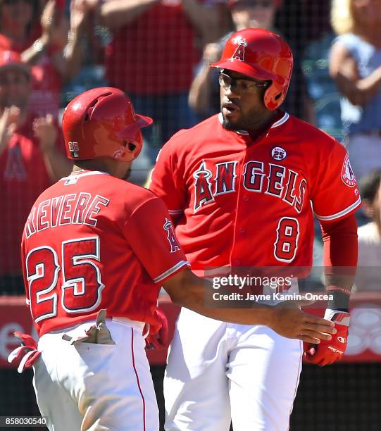 Ben Revere of the Los Angeles Angels of Anaheim congratulates Eric Young Jr. #8 of the Los Angeles Angels of Anaheim after he hit a three run home...