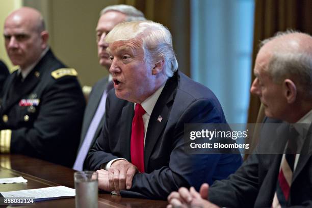 President Donald Trump, center, speaks as John Kelly, White House chief of staff, right, listens during a briefing with senior military leaders in...