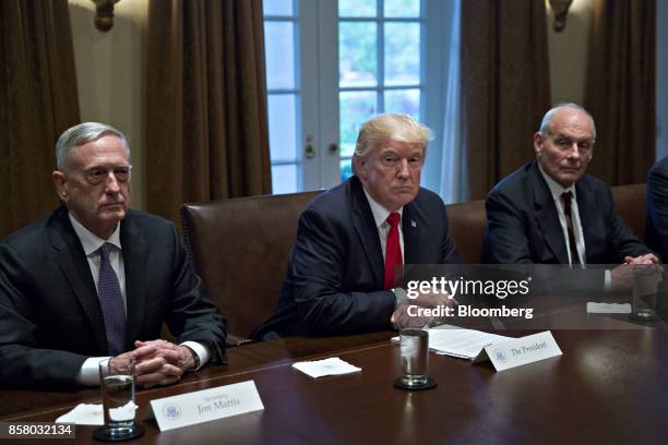 President Donald Trump, center, waits to speak while seated next to John Kelly, White House chief of staff, right, and Jim Mattis, U.S. Secretary of...