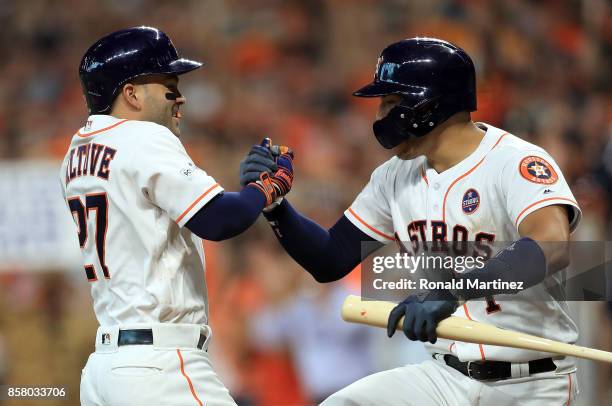 Jose Altuve of the Houston Astros celebrates his third homerun of the game with Carlos Correa during game one of the American League Division Series...