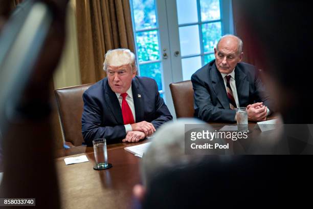 President Donald Trump speaks as White House chief of staff John Kelly at a briefing with senior military leaders in the Cabinet Room of the White...