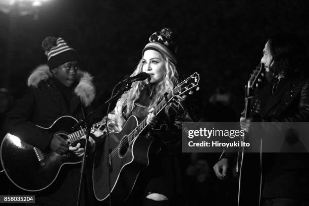 American Pop musician Madonna plays guitar during a surprise concert in support of Hillary Clinton's presidential candidacy, on the eve of Election...