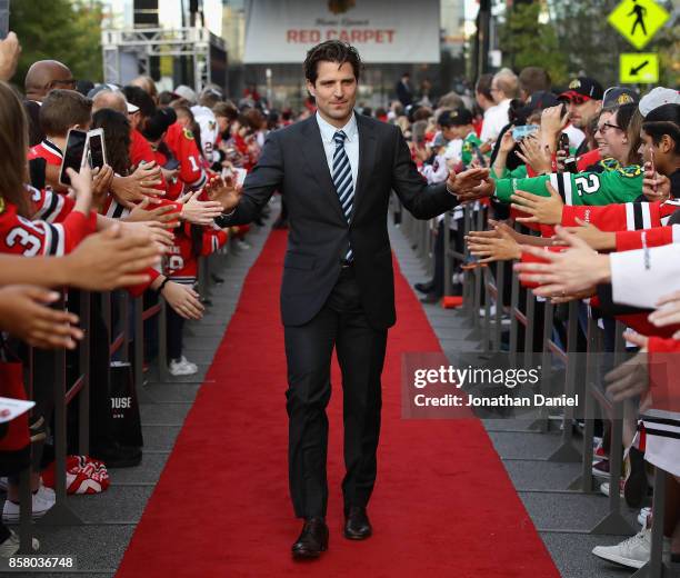 Patrick Sharp of the Chicago Blackhawks greets fans during a "red carpet" event before the season opening game against the Pittsburgh Penguins at the...