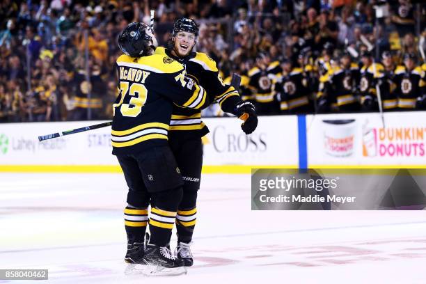 David Pastrnak of the Boston Bruins celebrates with Charlie McAvoy after scoring a goal against the Nashville Predators during the first period at TD...