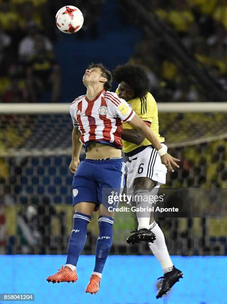 Carlos Sanchez of Colombia jumps for a header with Angel Romero of Paraguay during a match between Colombia and Paraguay as part of FIFA 2018 World...