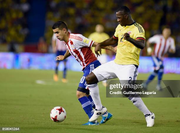 Cristian Zapata of Colombia struggles for the ball with Derlis Gonzalez of Paraguay during a match between Colombia and Paraguay as part of FIFA 2018...