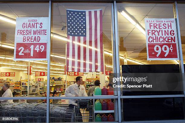 Grocery store advertises specials in it's window April 4, 2009 in economically depressed Binghamton, New York. A gunman killed 13 people in an...